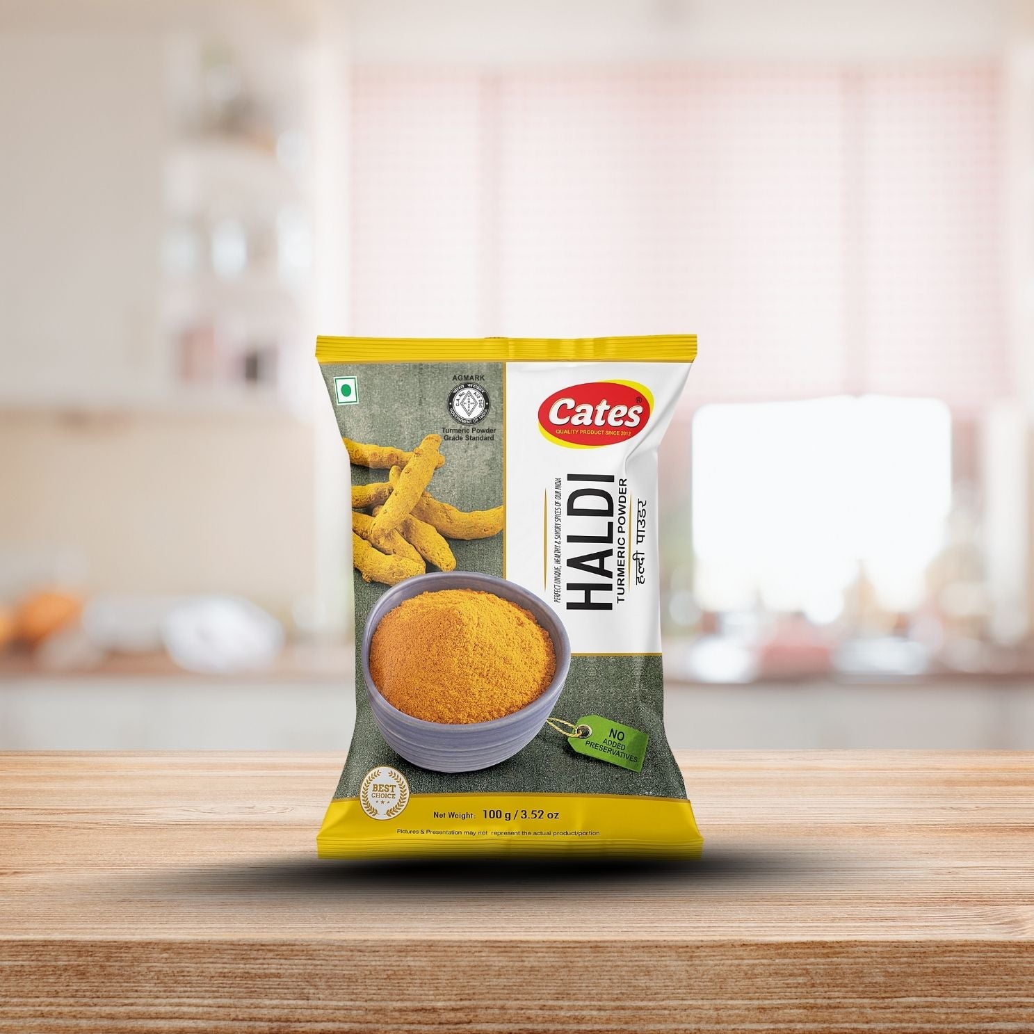 Cates Haldi spice powder packaging on a wooden surface with a blurred kitchen background