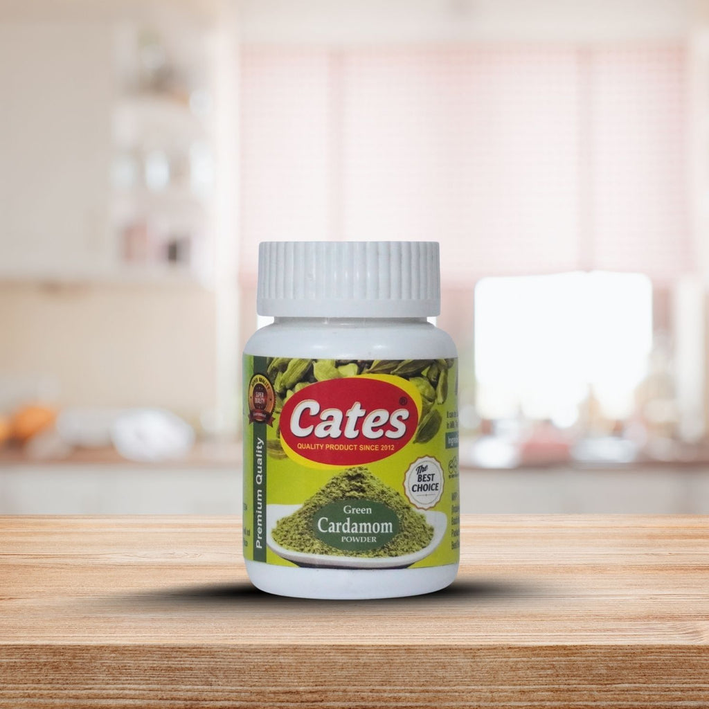 Bottle of Cates Green Cardamom Powder on a wooden surface with a blurred kitchen background