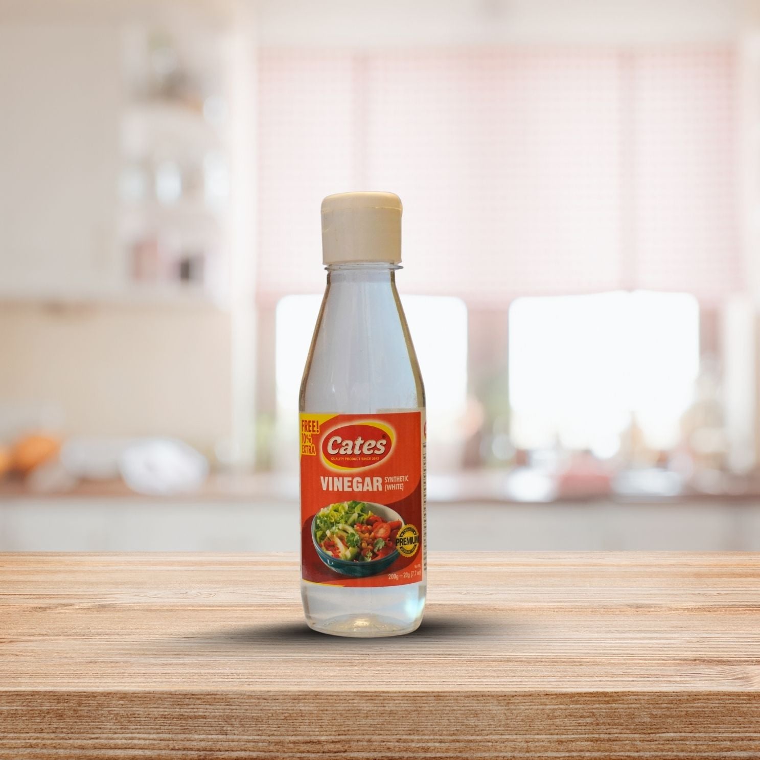 Bottle of Cates vinegar on a wooden surface with a blurred kitchen background